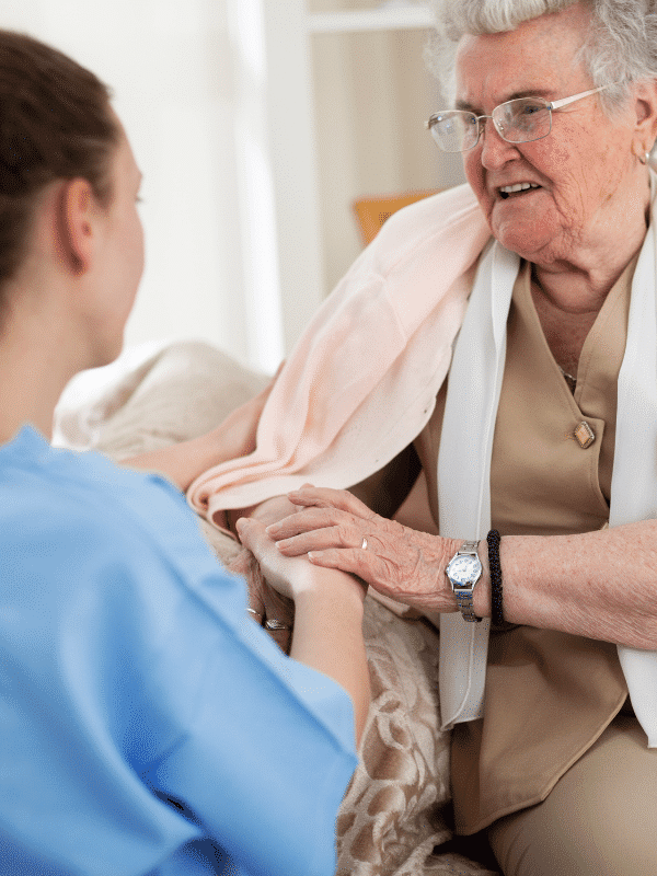 Multiple Sclerosis patient on sofa with carer